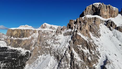 huge rock formation in the italian dolomites shot during winter season (drone footage)