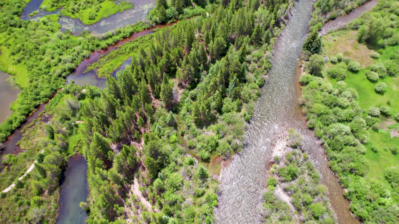 Aerial flight over water in Silverthorne, Colorado. Camera is looking mostly down and flying over various creeks, streams and rivers.