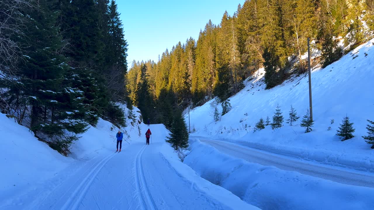 Holmenkollen Toppsesteret Skimore Oslo Norway Norge Frognerseteren Cross Country skiing trail path skiers gliding skating late afternoon arctic golden hour sunset river creek shaded area follow