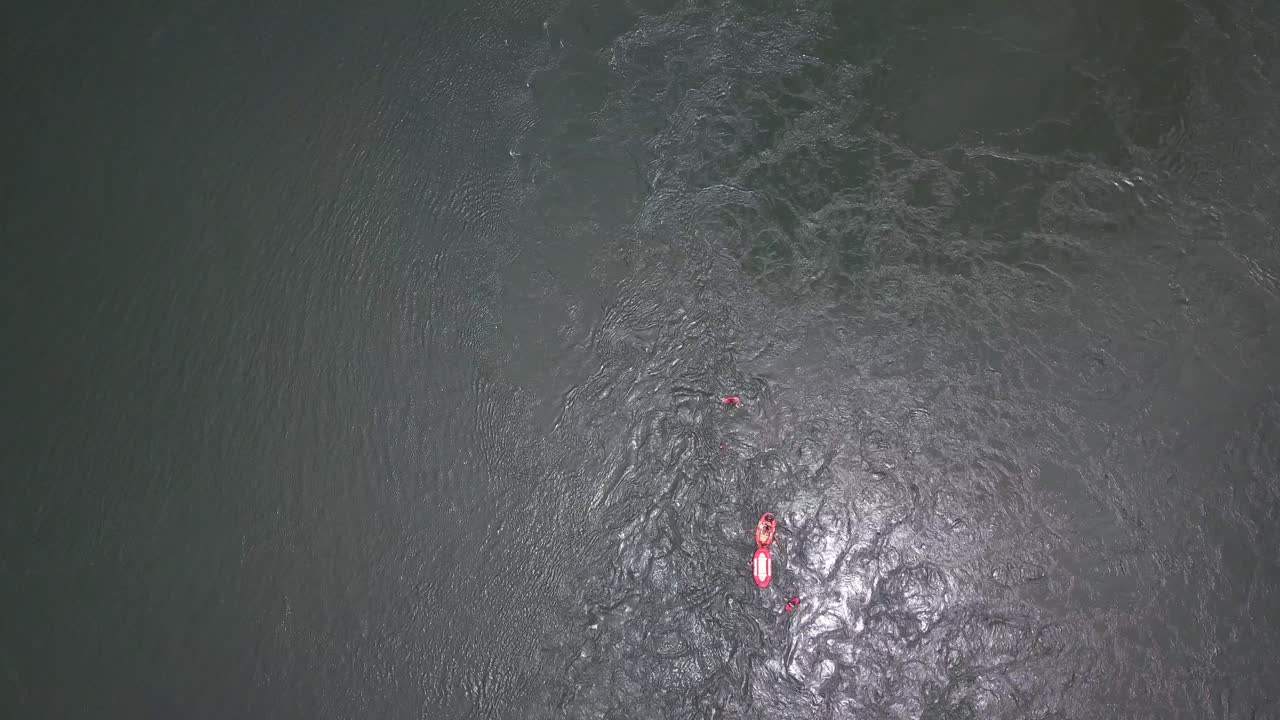 Top-down drone image of thrill-seekers rafting and paddleboarding on the River Nile in Uganda, showcasing dynamic water flow and outdoor adventure in East Africa’s iconic river landscape