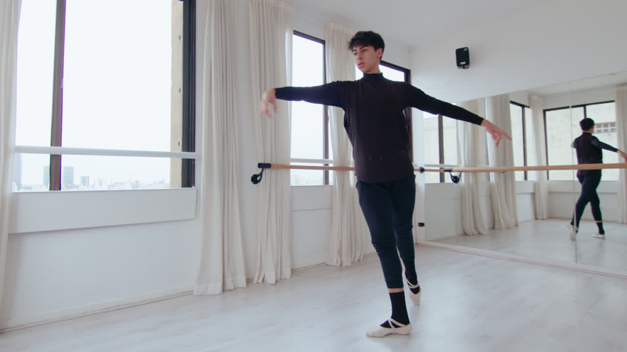 Professional Male Dancer Practicing Ballet Movements in Studio