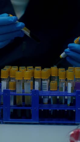 lab technician handling blood samples