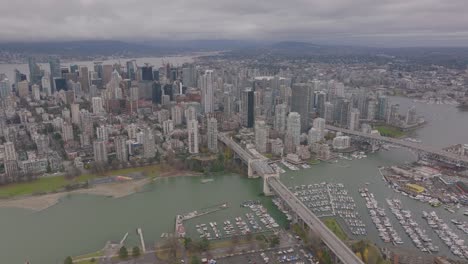 aerial footage of downtown vancouver with english bay and burrard street bridge in 4k
