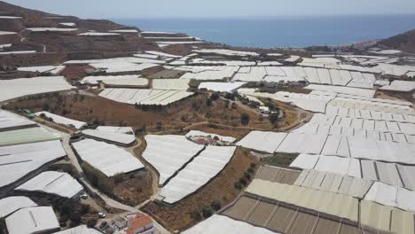 aerial tilt up shot on the coast of spain full of greenhouses