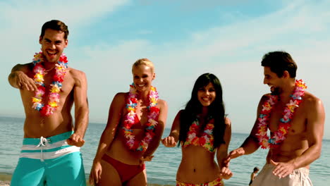 Friends-wearing-garlands-dancing-on-the-beach