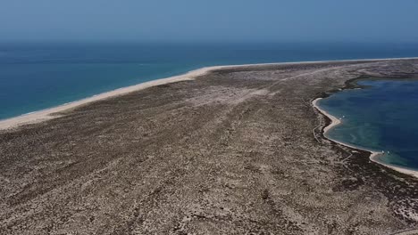 Aerial-pullback-form-scenic-Desert-island-in-Algarve,-Arid-peninsula-in-south-Portugal