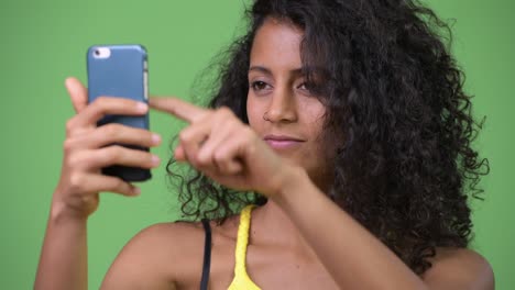 young beautiful hispanic woman using phone