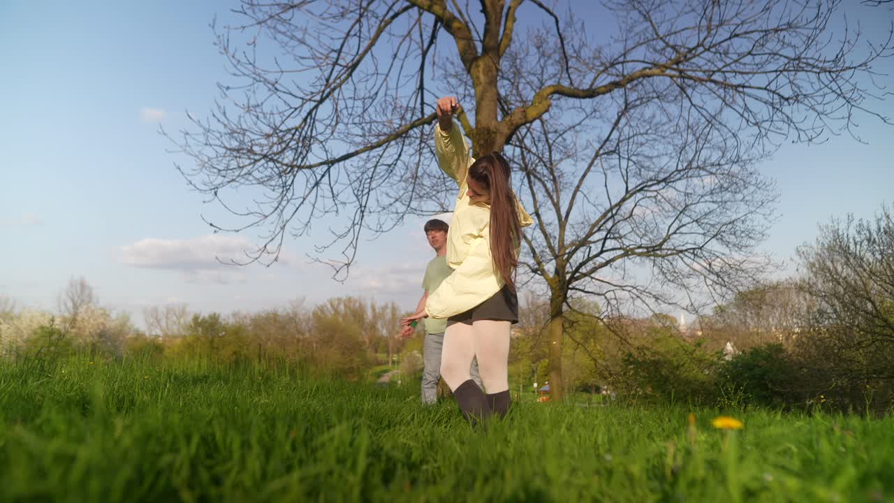 Couple Stretching and Dancing in a Park