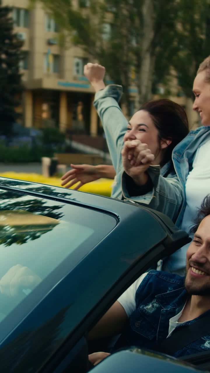 Friends enjoying a road trip in a convertible