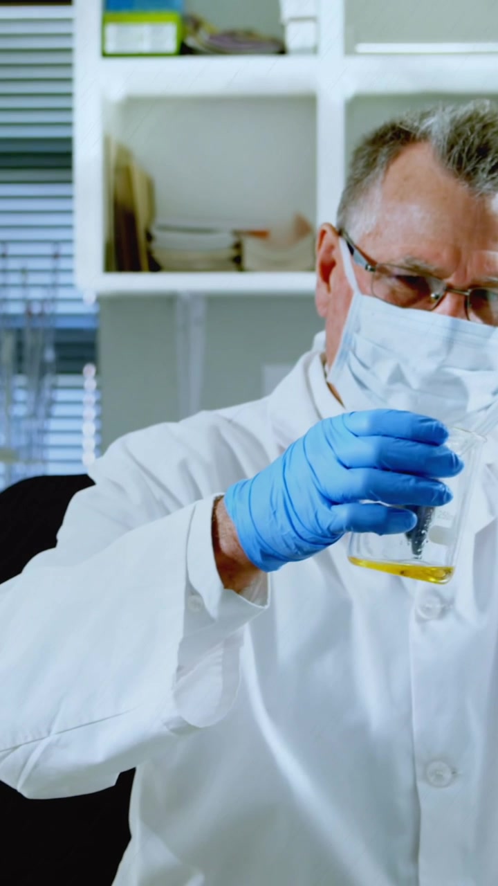 Animation of chemical formulas over caucasian senior male lab worker with sample