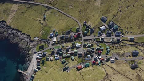 aerial tilt up shot showing small village of funningur on eysturoy in faroes island