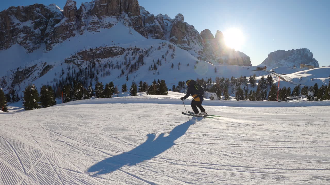 Skier on a sunny winter mountain slope