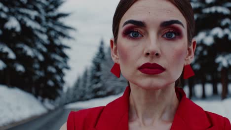 woman in red coat in snowy forest