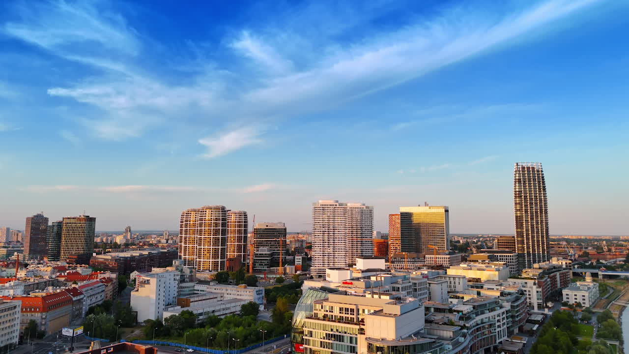 Flying over the varied urban landscape of Bratislava, Slovakia. Drone footage over the city at sunset time