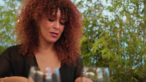 at the outdoor resort a woman smiling and laughing during a dinner