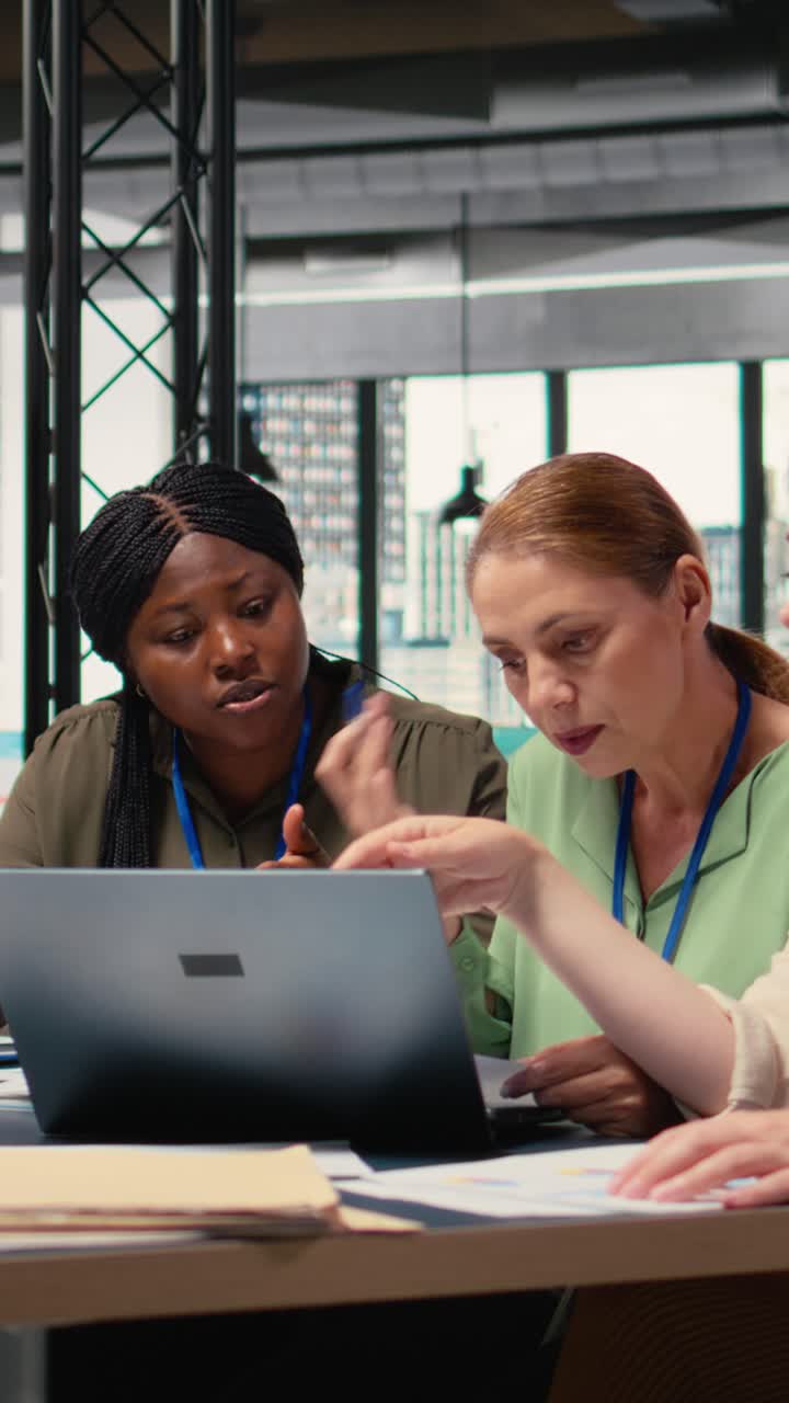 Vertical Video Confident powerful women gathering in the boardroom to evaluate data reports