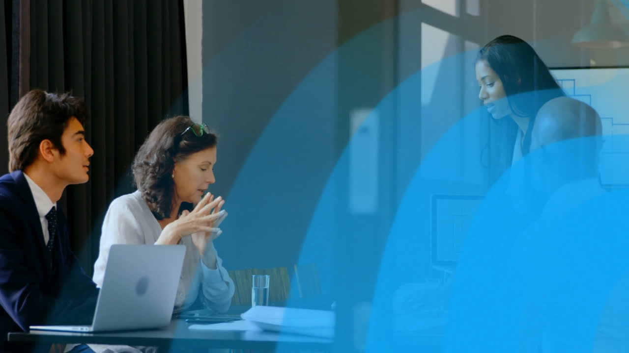 In school, professionals discussing animation with blue abstract shapes in meeting