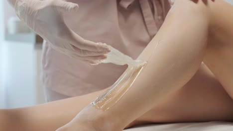 laser epilation - hair removal procedure. flash of diode laser hair removal, beautician removes hair on beautiful female legs, hair removal for smooth skin, laser procedure at beauty studio or clinic, body care epilation treatment.