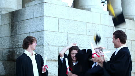 graduates throwing mortar boards in the air