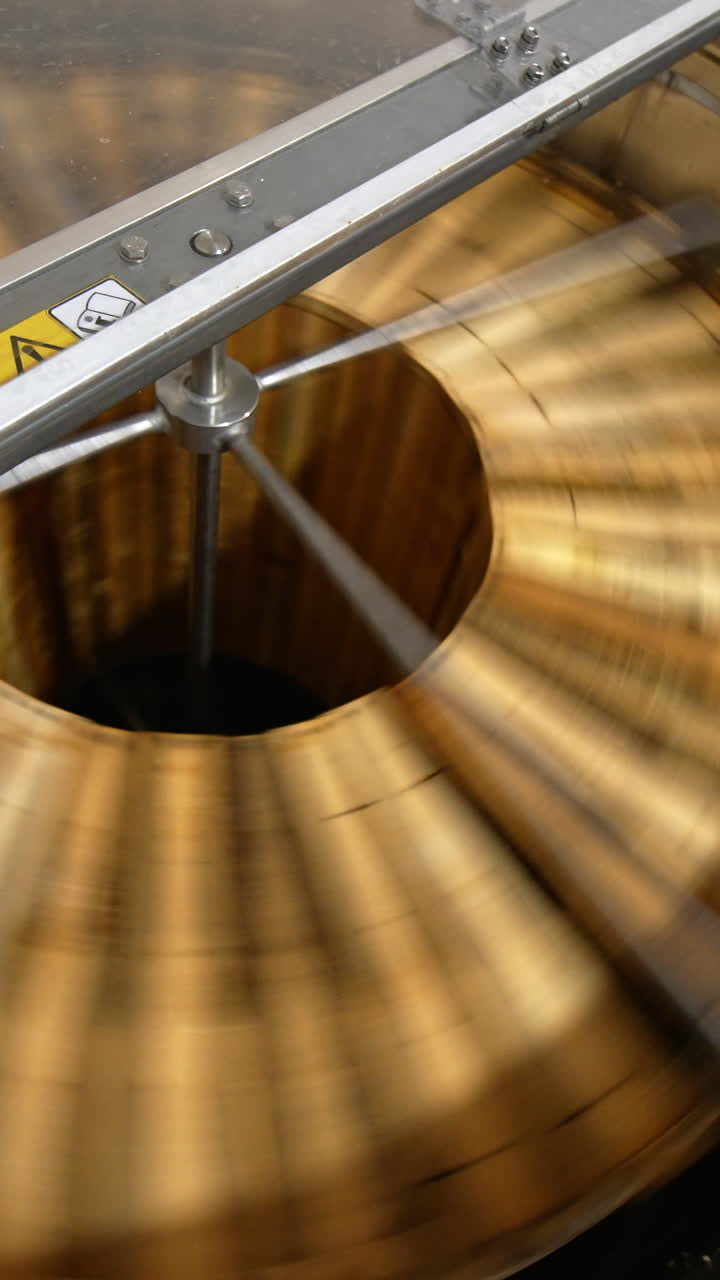 Centrifuge machine spinning the wooden frames to remove organic honey. Electric machine quickly rotating close up. Top view. Vertical video