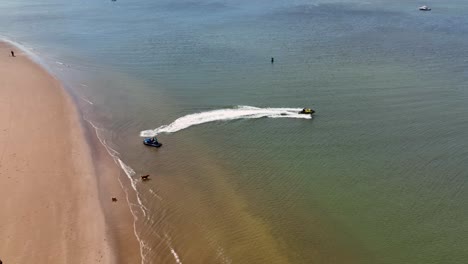 An-aerial-view-of-the-beach-at-Gravesend-Bay-in-Brooklyn,-NY-as-two-jet-ski-riders-prepare-to-ride