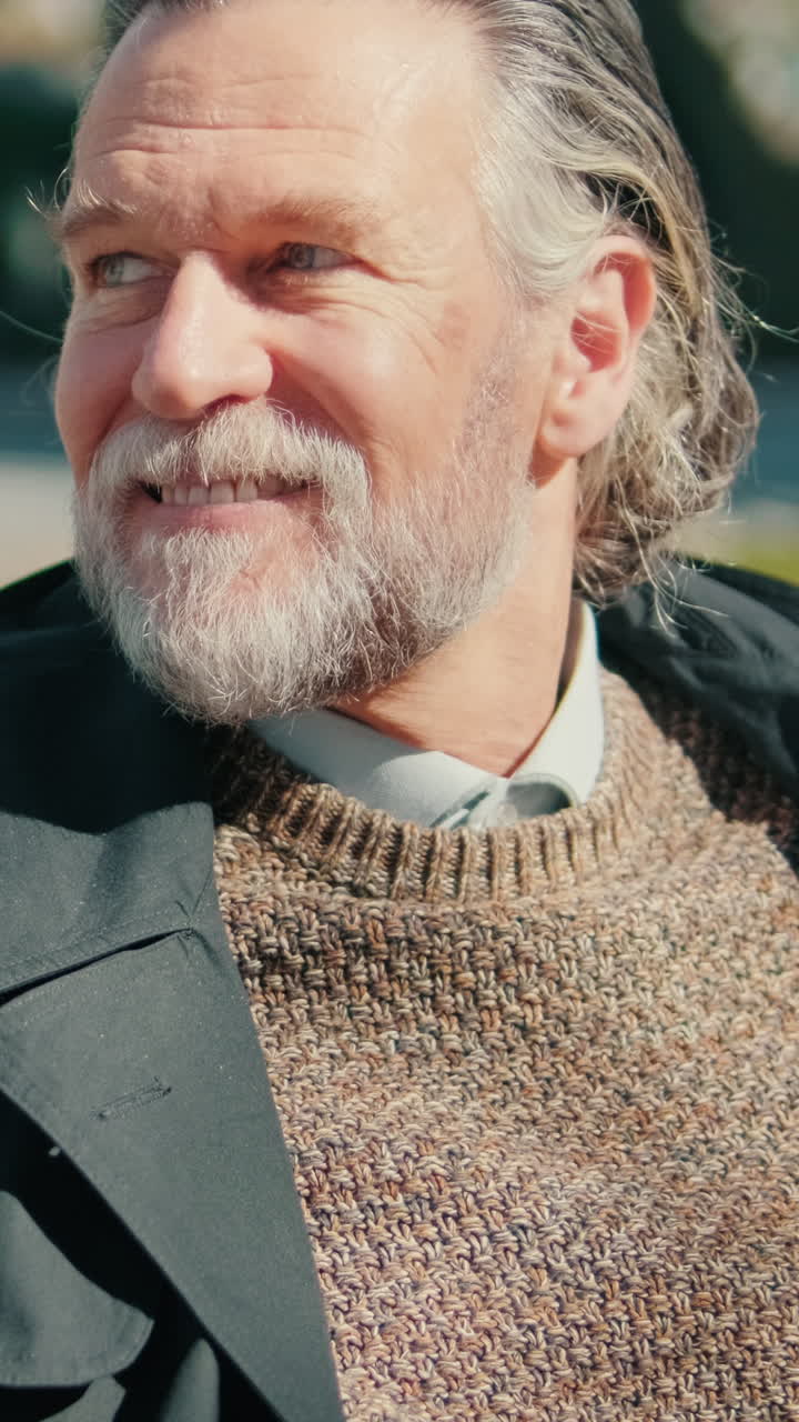 Thoughtful Senior Man Sitting on Park Bench