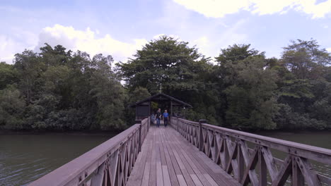 a man and a woman walking at the main bridge on a sunny day - medium shot