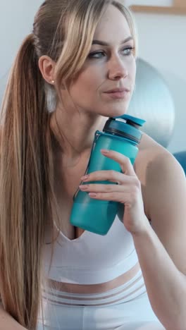woman in sportswear with water bottle