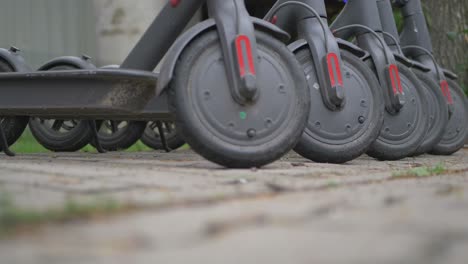 row of gray electric scooters