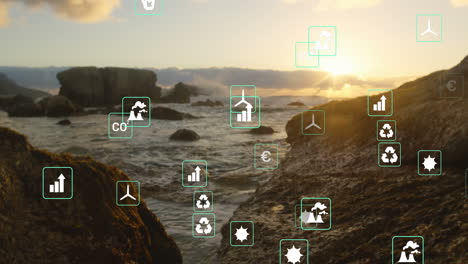 animation of green energy concept icons floating against view of rocks and the sea