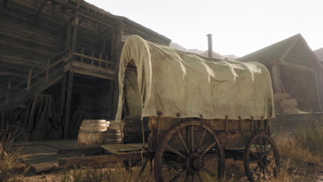 old west covered wagon in dusty desert town