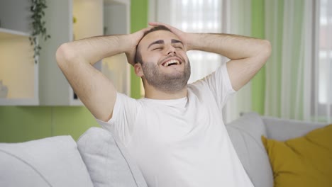 man relaxing and resting on sofa at home.