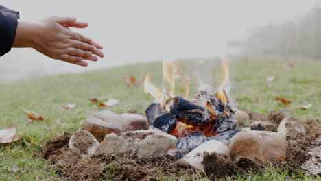 Camp,-fire-and-warm-hands-in-nature-to-relax