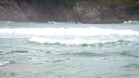 Ocean-waves-breaking-into-the-shore-on-the-beach-in-Phuket,-Thailand