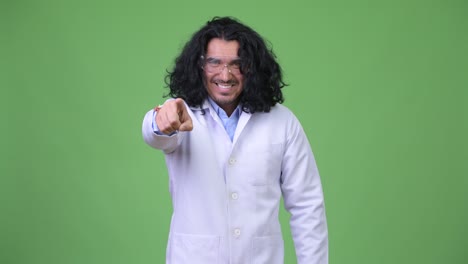 crazy scientist wearing protective glasses pointing to camera