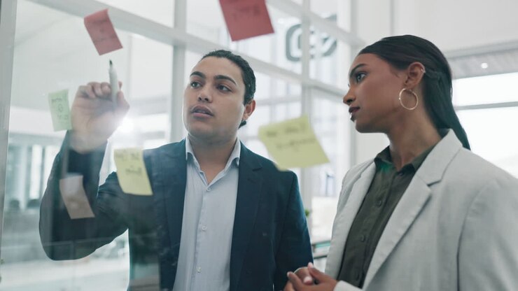 Glass wall, teamwork and business people planning