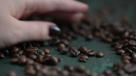 Hand-pouring-hot-steaming-coffee-beans