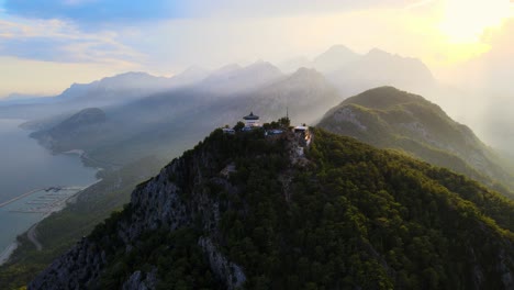 aerial 4k drone video of a tunektepe teleferik
cable station positioned on top of the hill with the mountains in the background