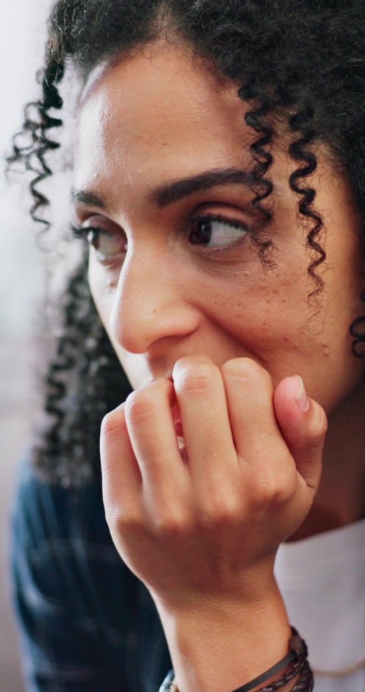Young Woman Looking Anxious and Pensive
