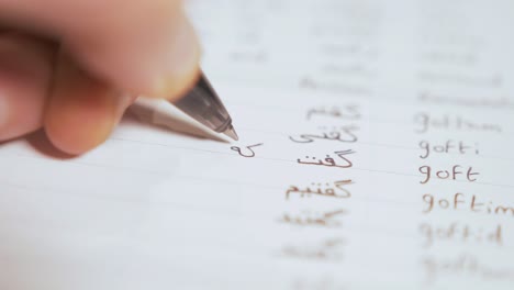 writing persian  verbs in notebook while learning