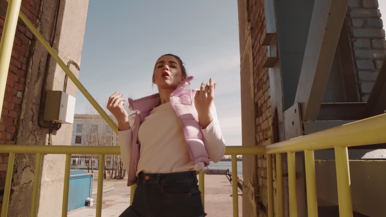Woman Dancing on Industrial Bridge Stairwell