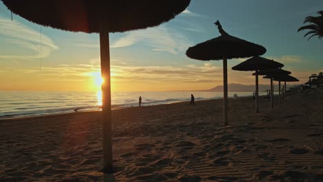 sunset view at the beach behind resort parasols