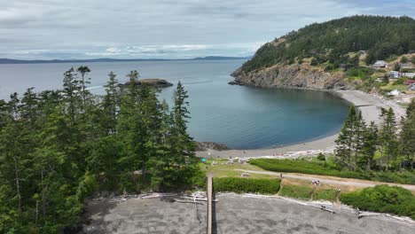 aerial view rising over a dock to reveal rosario beach and its protected cove