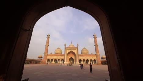 reveal shot of jama masjid though an archway