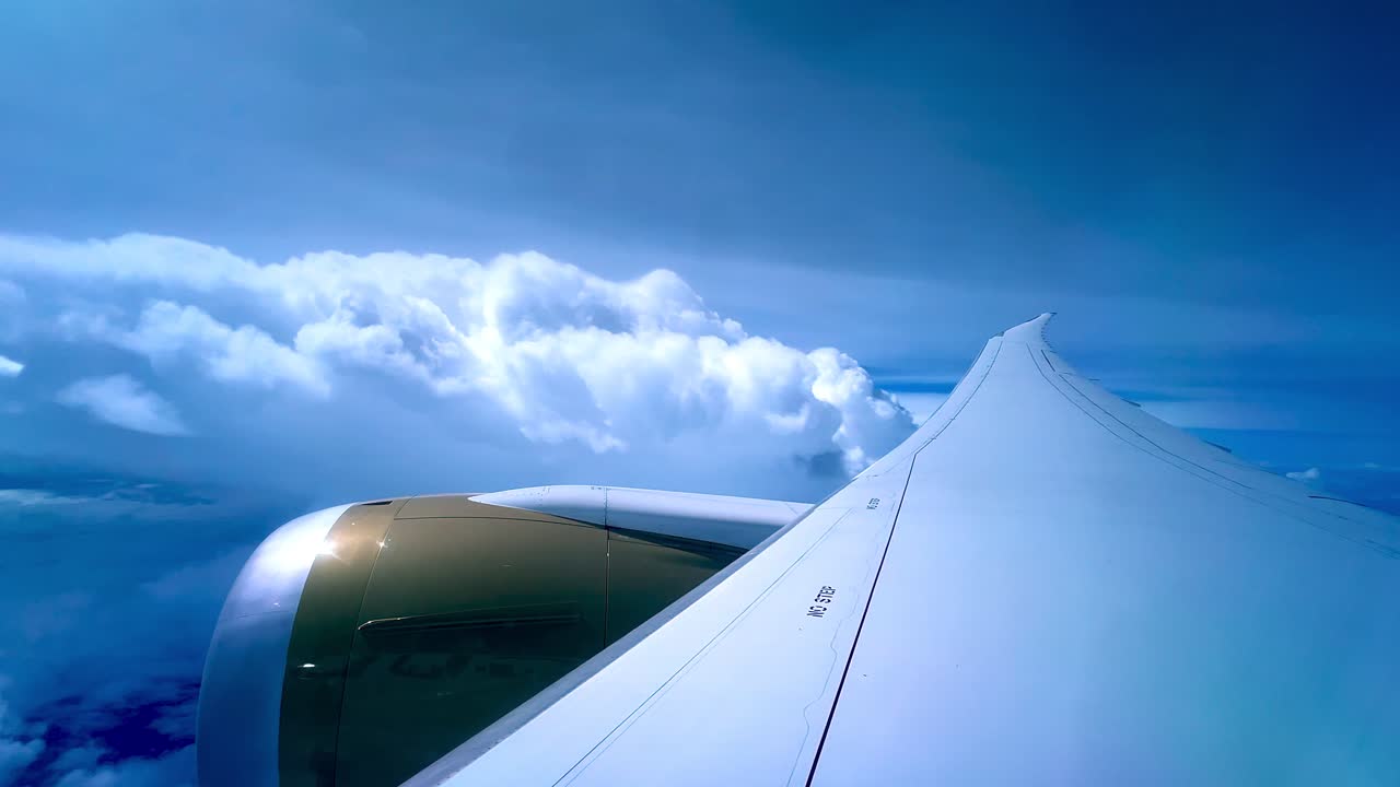 Stunning view from airplane window showing aircraft wing, engine, and bright clouds, ideal for travel, aviation, airline, wanderlust, and journey-related projects