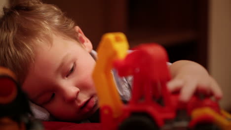 Two-year-old-boy-plays-with-toy-trucks