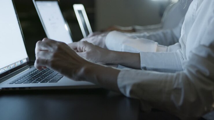 Delvis visning af kolleger, der taster på laptops