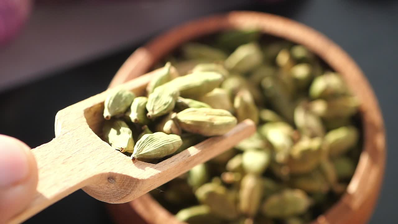 Cardamom in a Wooden Spoon and Bowl