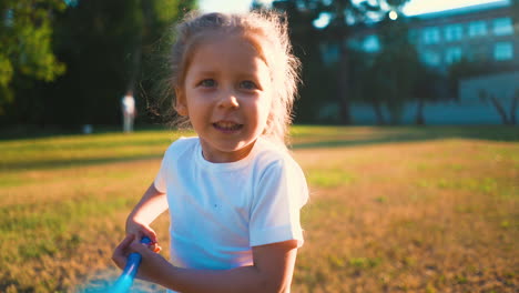 cute girl runs along lawn catching butterflies on sunny day 2