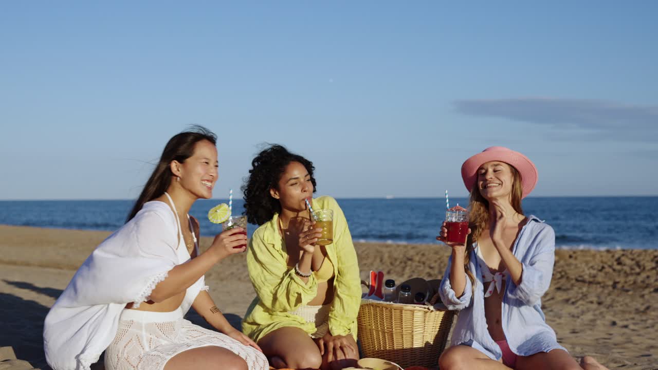 Friends toasting with cocktails at the beach